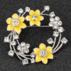 JD279412-Daffodil Round Brooch Golden yellow daffodil brooch showing detailed flower petals and tac pin fastening